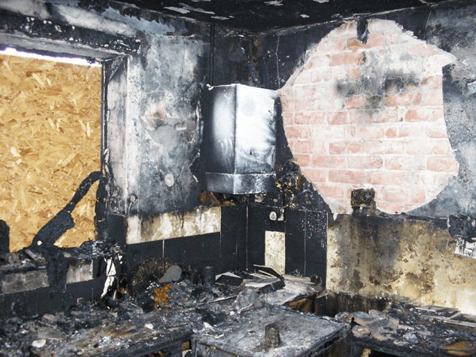 a badly burnt out room in a fire damaged house
